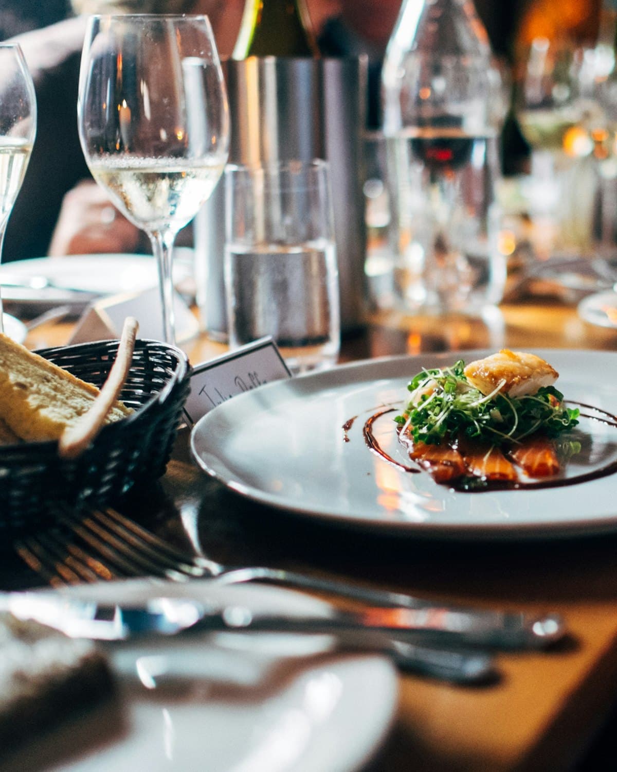 A plated dish set down at a candlelit table