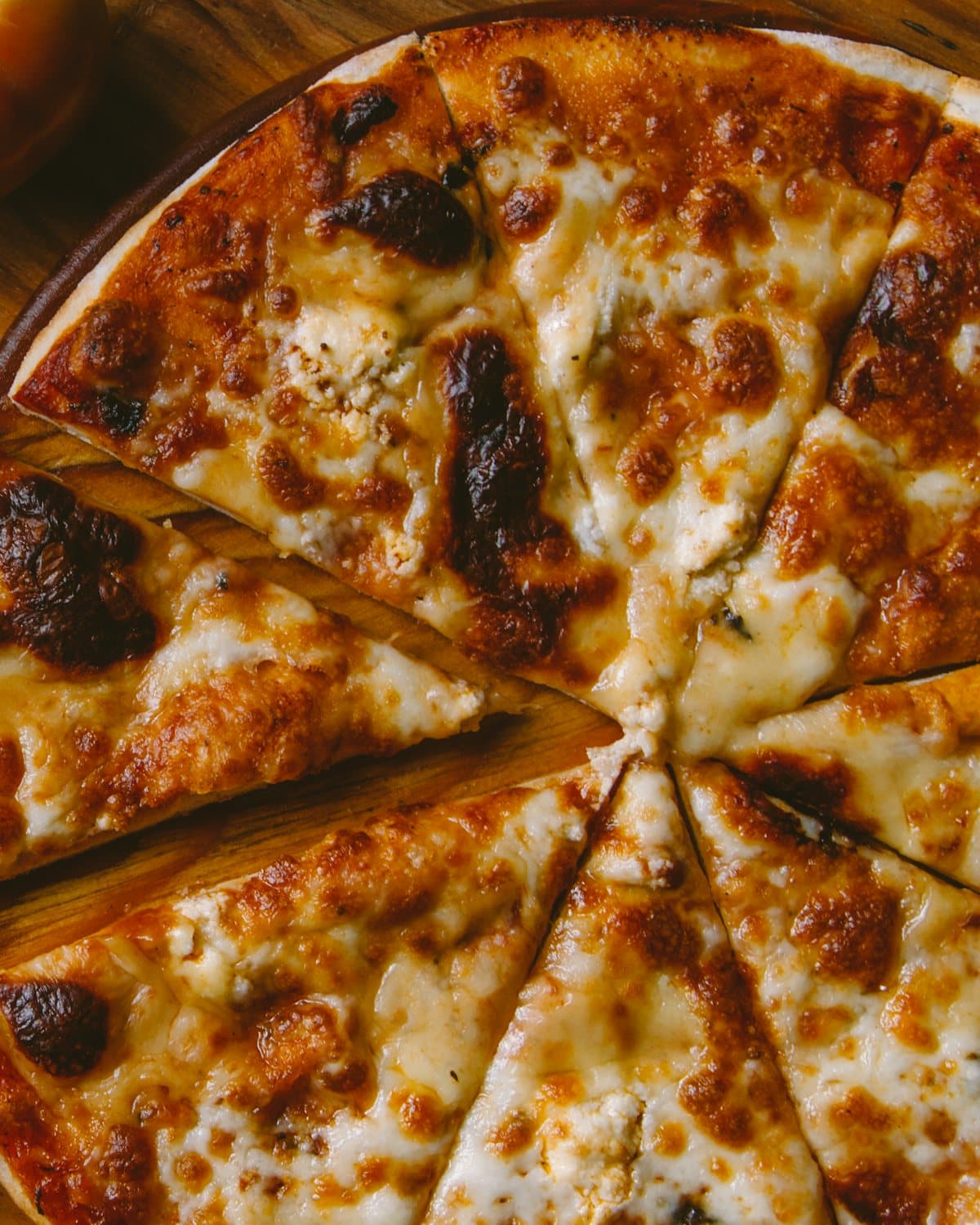 A pizza straight from the oven, just cut