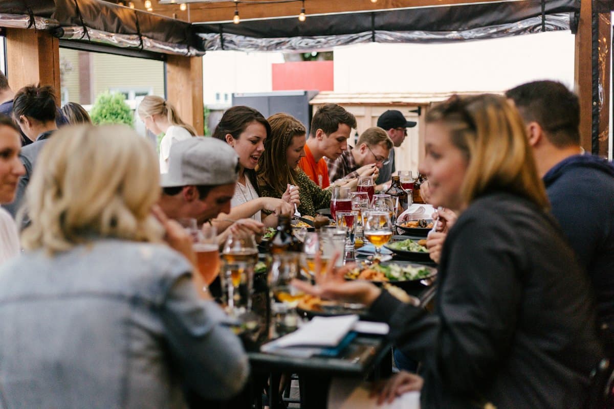 A long table in full swing, mid-service